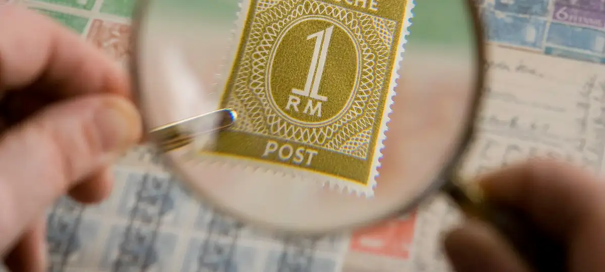 Philately, Magnifying glass shows the magnified image of the Deutsche Post 1 Reichsmark postage stamp issued on May 12 1946.