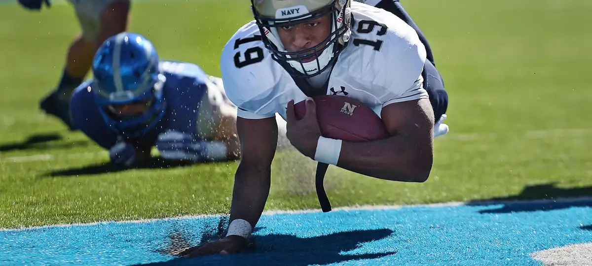 Navy quarterback Keenan Reynolds lands in the end zone for a touchdown against Air Force at the Air Force Academy in Colorado Spri